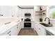 Modern kitchen featuring sleek white cabinets, stainless steel appliances, and a trendy black sink at 1012 E Estevan Ave, Apache Junction, AZ 85119