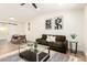 Inviting living room featuring modern art, a comfortable sofa, and a dining area with stylish furniture at 1012 E Estevan Ave, Apache Junction, AZ 85119