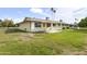 A charming home features a covered patio and well-maintained backyard lawn at 10927 W Peoria Ave, Sun City, AZ 85351