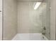 Beautiful bathroom featuring a bathtub with tiled walls and glass door at 10927 W Peoria Ave, Sun City, AZ 85351