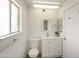 Modern bathroom with toilet, vanity, mirror, and a window providing natural light at 10927 W Peoria Ave, Sun City, AZ 85351