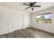 Cozy bedroom features a ceiling fan, window with an outside view, and a closet at 10927 W Peoria Ave, Sun City, AZ 85351