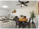 Open dining and living room area featuring stylish furnishings, fan, and modern flooring at 10927 W Peoria Ave, Sun City, AZ 85351
