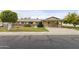 Charming single-story home with a well-manicured lawn and covered carport at 10927 W Peoria Ave, Sun City, AZ 85351