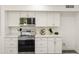 Bright kitchen featuring stainless steel appliances and white cabinets, offering a clean and modern design at 10927 W Peoria Ave, Sun City, AZ 85351