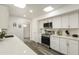 Well-lit kitchen with stainless appliances, modern countertops, and white subway tile backsplash at 10927 W Peoria Ave, Sun City, AZ 85351