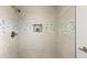 Shower features neutral-toned tile and a modern shower head, creating a clean and inviting space at 10927 W Peoria Ave, Sun City, AZ 85351