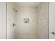 Updated shower showcasing stylish tile work, a niche, and modern fixtures at 10927 W Peoria Ave, Sun City, AZ 85351
