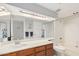 Bright bathroom with a shower-tub combo, spacious vanity, and a large mirror at 1211 N Miller Rd # 213, Scottsdale, AZ 85257