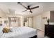 Bright bedroom featuring neutral tones, ceiling fan, plush carpet and closet with mirrored sliding doors at 1211 N Miller Rd # 213, Scottsdale, AZ 85257