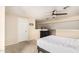 Bedroom featuring neutral tones, ceiling fan, plush carpet, black dresser and door at 1211 N Miller Rd # 213, Scottsdale, AZ 85257