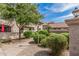 Exterior view with lush bushes and manicured landscaping at 1211 N Miller Rd # 213, Scottsdale, AZ 85257