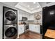 Bright kitchen with stainless steel appliances, including a stacked washer and dryer at 1211 N Miller Rd # 213, Scottsdale, AZ 85257