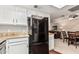Well-lit kitchen area with granite countertops and a view into the living room and dining area at 1211 N Miller Rd # 213, Scottsdale, AZ 85257