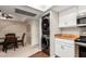 Modern kitchen with stainless steel appliances, dining area, and stacked washer/dryer at 1211 N Miller Rd # 213, Scottsdale, AZ 85257