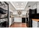 Modern kitchen featuring stainless steel appliances, granite countertops, wooden floors, and stacked washer dryer at 1211 N Miller Rd # 213, Scottsdale, AZ 85257