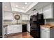 Clean kitchen with white cabinets, granite countertops, modern appliances, and wood-look flooring at 1211 N Miller Rd # 213, Scottsdale, AZ 85257