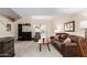 Inviting living room with plush brown sofa, fireplace, and lots of natural light at 1211 N Miller Rd # 213, Scottsdale, AZ 85257