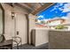 Charming outdoor patio area with a chair, white door, and views of the neighborhood at 1211 N Miller Rd # 213, Scottsdale, AZ 85257