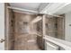 Shower with glass enclosure, tile surround, built-in niche, a shower seat, and modern fixtures at 1211 N Miller Rd # 213, Scottsdale, AZ 85257