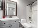 This newly renovated bathroom features modern fixtures and a vanity with storage at 12427 W El Nido Ln, Litchfield Park, AZ 85340