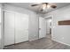 This bedroom features wood-look tile flooring and two closets, one of which leads to the en-suite bathroom at 12427 W El Nido Ln, Litchfield Park, AZ 85340