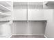 Spacious walk-in closet featuring shelving and rods for ample storage and organization at 12427 W El Nido Ln, Litchfield Park, AZ 85340