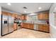 Bright kitchen featuring stainless steel appliances, oak cabinets, tile flooring, and natural light at 12427 W El Nido Ln, Litchfield Park, AZ 85340