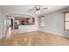 Open-concept living room showcasing the kitchen with stainless steel appliances and ample cabinet space at 12427 W El Nido Ln, Litchfield Park, AZ 85340