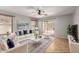 Bright living room with a comfortable white sofa, large windows, and access to the backyard at 12427 W El Nido Ln, Litchfield Park, AZ 85340