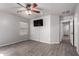Main bedroom with neutral walls, tile floors, ceiling fan, window, closet, and bathroom access at 12427 W El Nido Ln, Litchfield Park, AZ 85340
