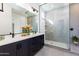 Sleek bathroom boasts a dual sink vanity and a frameless glass shower at 14407 N 75Th Dr, Peoria, AZ 85381