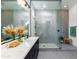 Modern bathroom with dual sinks, a walk-in shower, and neutral gray finishes at 14407 N 75Th Dr, Peoria, AZ 85381