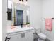 Clean bathroom features white cabinetry, black hardware, and a large mirror at 14407 N 75Th Dr, Peoria, AZ 85381