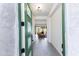 Green door opens to modern home's entryway and well-lit living space at 14407 N 75Th Dr, Peoria, AZ 85381