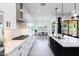 Contemporary kitchen boasts stainless appliances, quartz counters, and eat-in breakfast space at 14407 N 75Th Dr, Peoria, AZ 85381