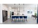 Open kitchen featuring a large island with barstool seating, stainless appliances, and modern lighting at 14407 N 75Th Dr, Peoria, AZ 85381