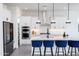 Gourmet kitchen featuring stainless appliances, quartz counters, and modern pendant lighting at 14407 N 75Th Dr, Peoria, AZ 85381