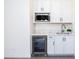 Modern kitchenette features a stainless steel mini-fridge, white cabinets, and a stylish countertop at 14407 N 75Th Dr, Peoria, AZ 85381