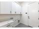 Functional laundry room equipped with white cabinets and a countertop at 14407 N 75Th Dr, Peoria, AZ 85381