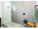 Stylish walk-in shower includes built-in shelves, matte gray tile, and a wooden bench at 14407 N 75Th Dr, Peoria, AZ 85381