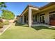 Expansive backyard featuring a covered patio and lush lawn, perfect for outdoor entertaining and relaxation at 1557 W Laurel Greens Ct, Anthem, AZ 85086