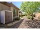 Landscaped backyard featuring storage shed, covered patio, vibrant plants, and easy access from home, perfect for outdoor living at 1557 W Laurel Greens Ct, Anthem, AZ 85086