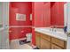 Vibrant half bathroom featuring bright walls, modern vanity, decorative mirror and tile floors at 1557 W Laurel Greens Ct, Anthem, AZ 85086