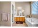 Primary bathroom features a soaking tub, shower, vanity, and ample counter space at 1557 W Laurel Greens Ct, Anthem, AZ 85086
