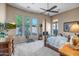 Spacious primary bedroom with ceiling fan, large windows with backyard views, and warm neutral tones at 1557 W Laurel Greens Ct, Anthem, AZ 85086