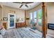 A cozy primary bedroom featuring multiple windows and a door to the backyard at 1557 W Laurel Greens Ct, Anthem, AZ 85086