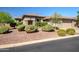 Charming home featuring desert landscaping, a quaint front entry and a neutral color palette at 1557 W Laurel Greens Ct, Anthem, AZ 85086