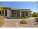 View of home exterior showcases a covered patio, manicured landscaping, and desert-friendly yard, ideal for outdoor enjoyment at 1557 W Laurel Greens Ct, Anthem, AZ 85086