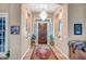 Elegant foyer featuring a decorative chandelier, wood flooring, and a dark wood door at 1557 W Laurel Greens Ct, Anthem, AZ 85086